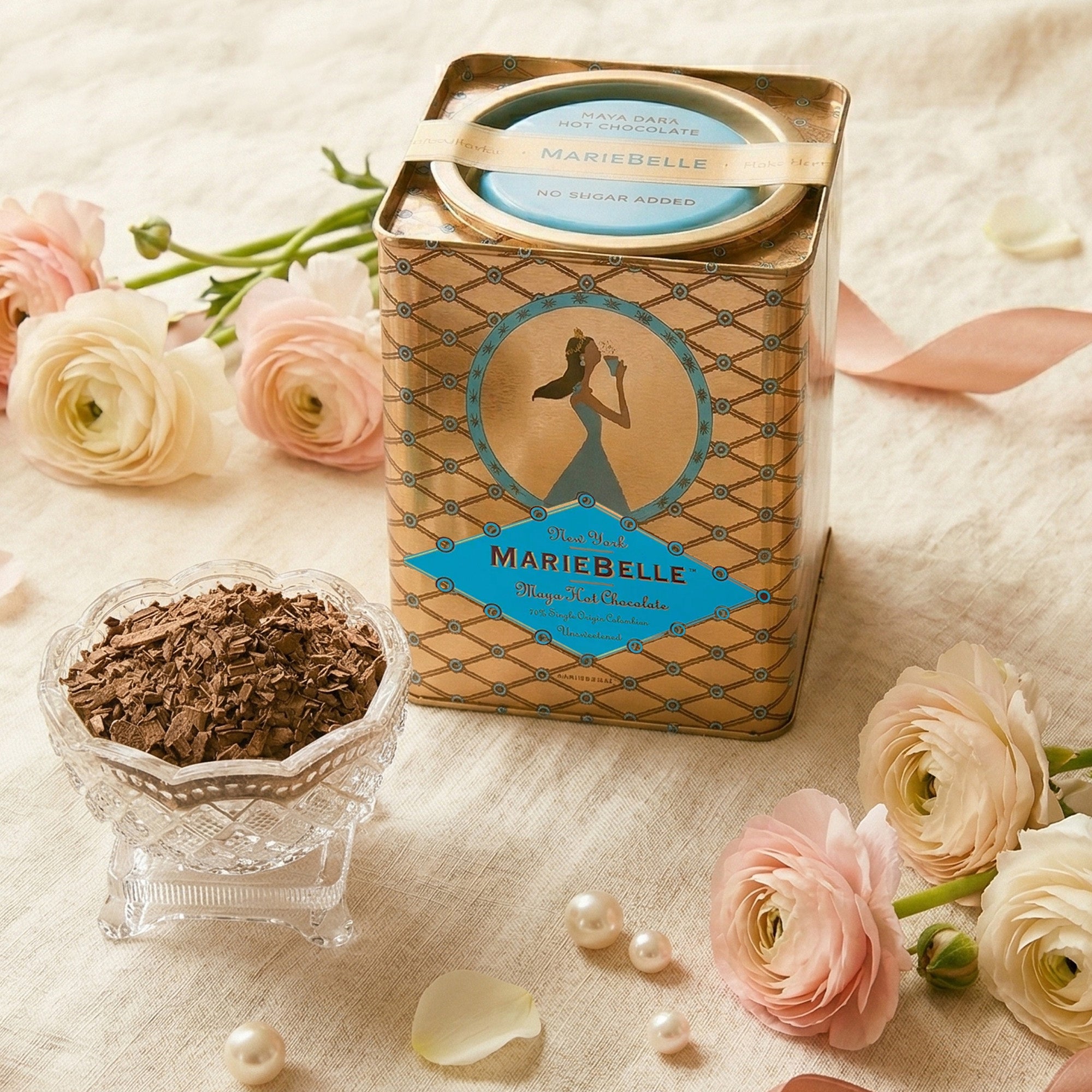 Mariebelle chocolate packaging with flowers and chocolate pieces on a soft background