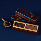 Chocolate Fin Du Grand in a gift box with a ribbon on a dark blue background