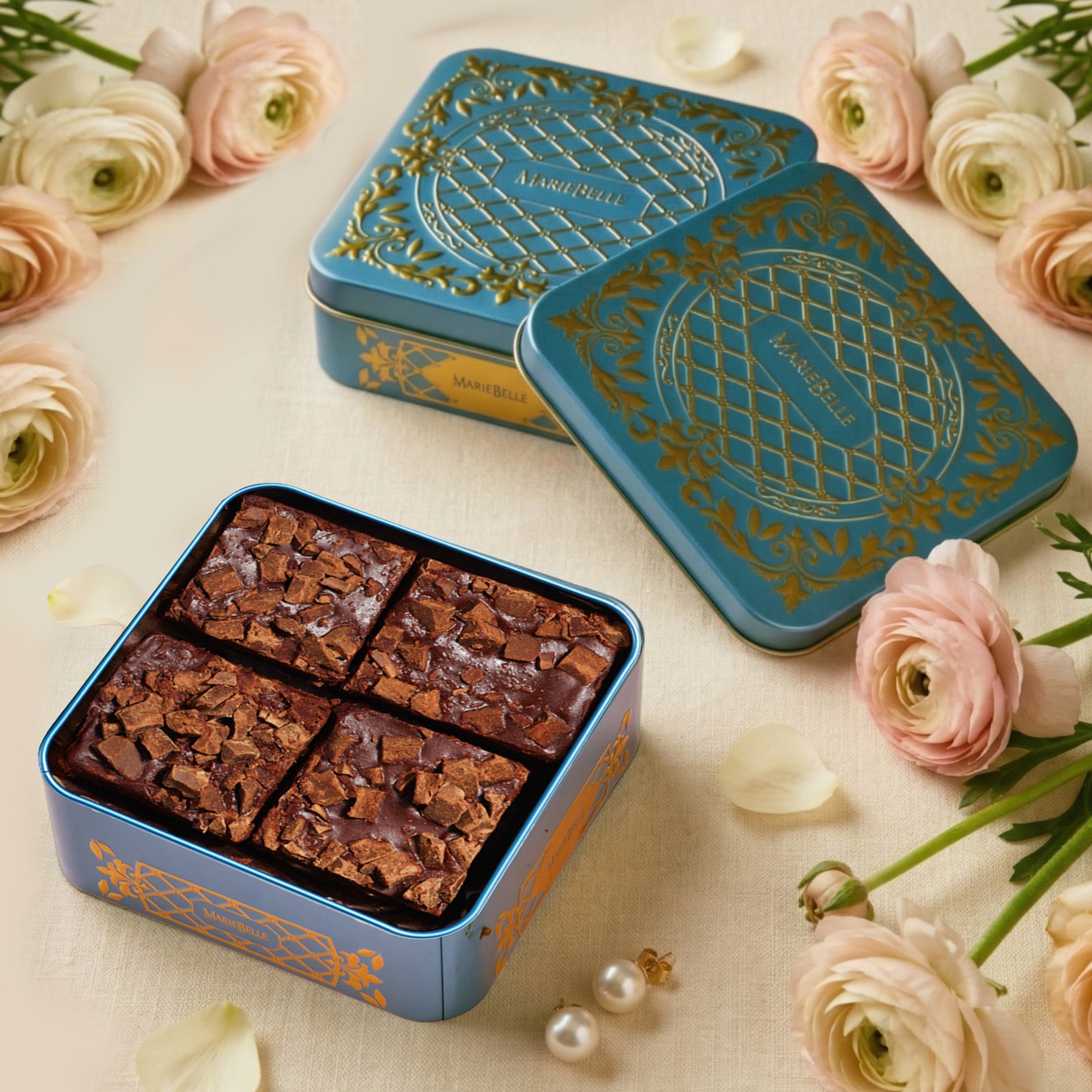 Decorative brownie tins with brownies and flowers on a light background