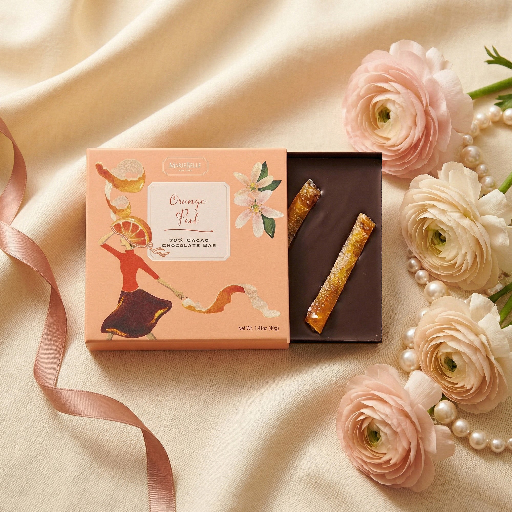 Chocolate bar with packaging on a soft fabric background with flowers and a ribbon